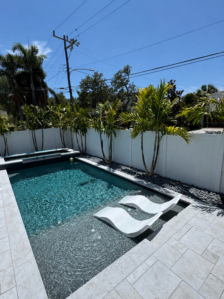 Finished clean residential swimming pool in St. Petersburg FL with a flamingo float